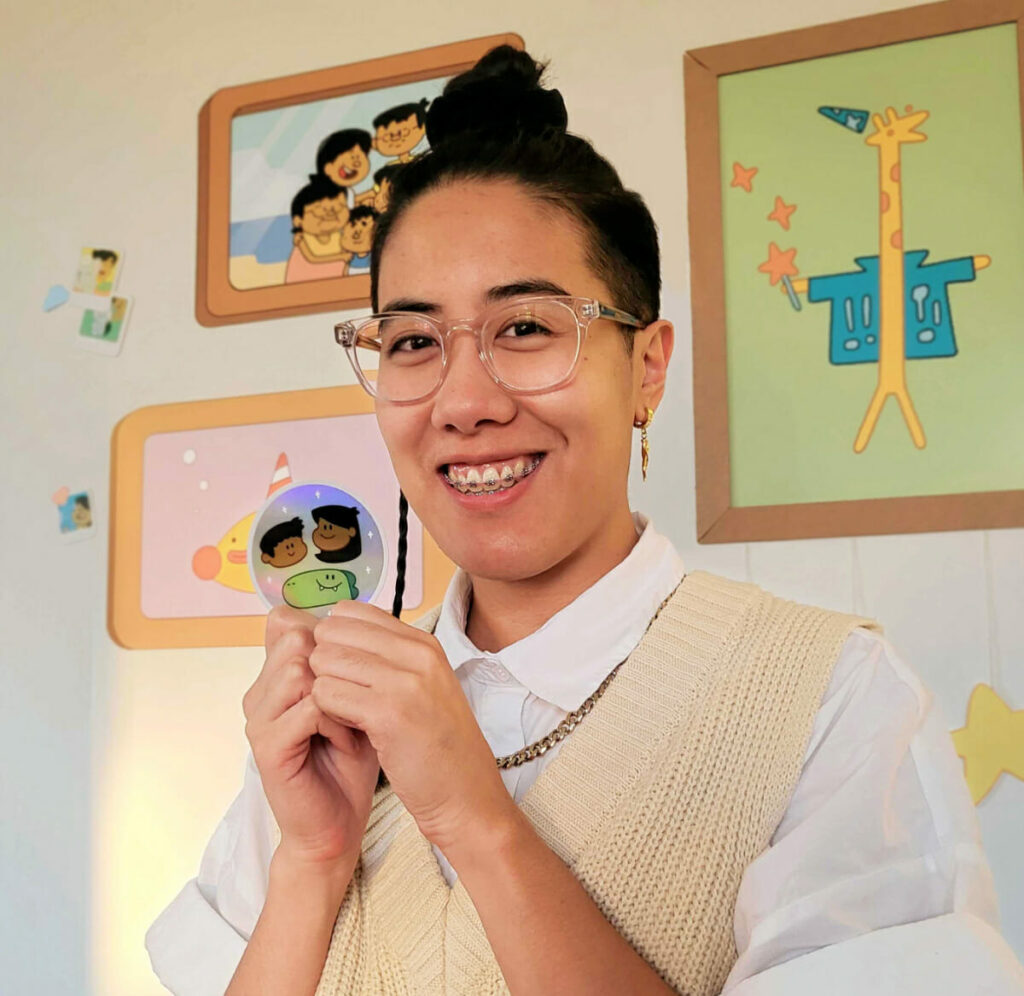 Jalysa Leva holding a drawing of Jelly, Ben & Pogo.